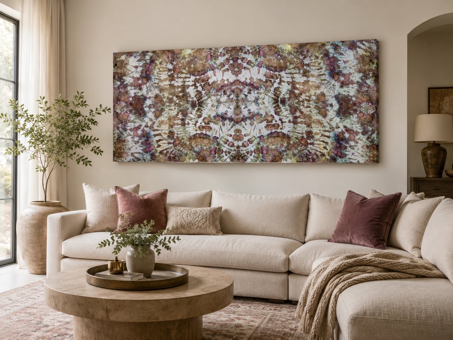 Autumn Alchemy hanging as large-format textile wall art. Shown above a low sofa in a warm, neutral transitional interior.